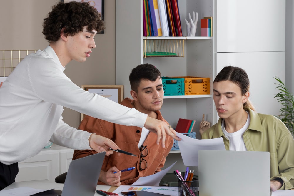 Young students collaborating in a modern, simulated office environment