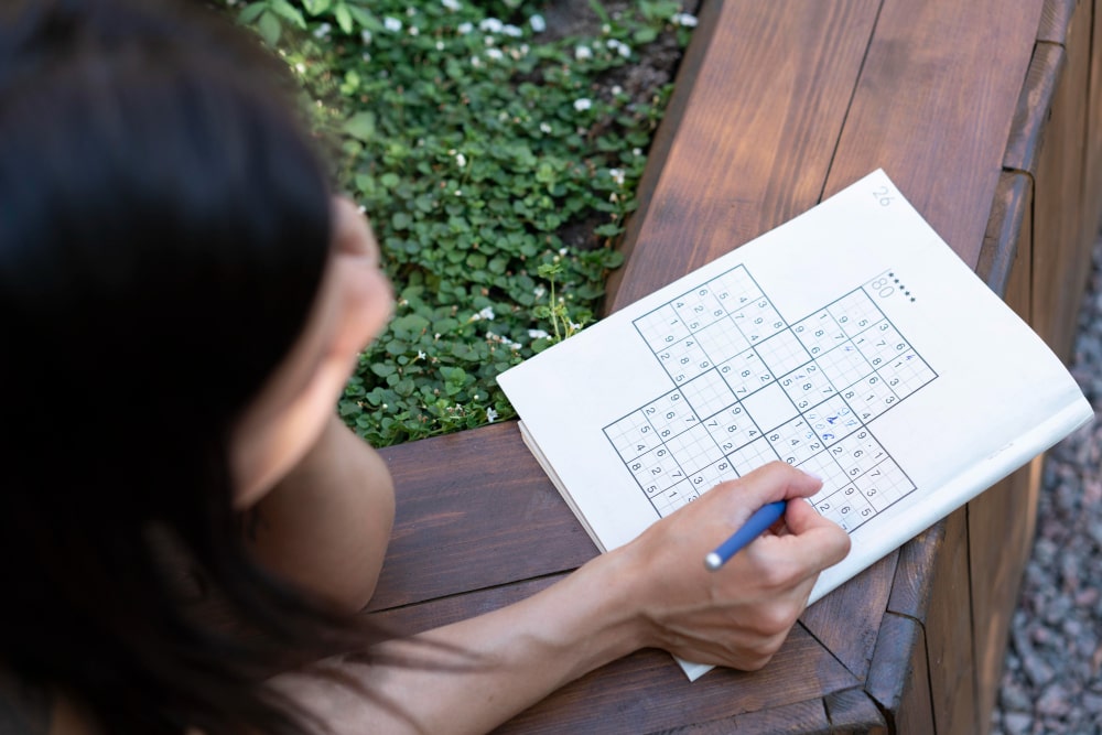 A person deeply focused on solving a complex puzzle, representing logical reasoning.